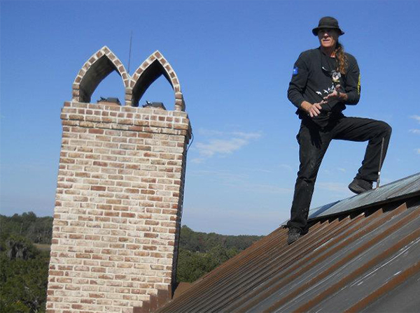 chimney sweep on a rooftop