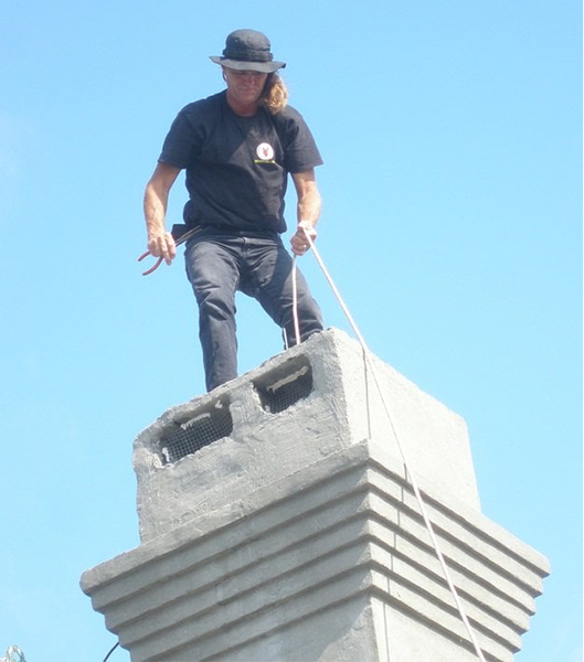 man standing on top of chimney